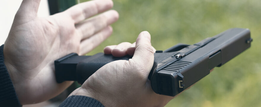 Person loading a handgun.